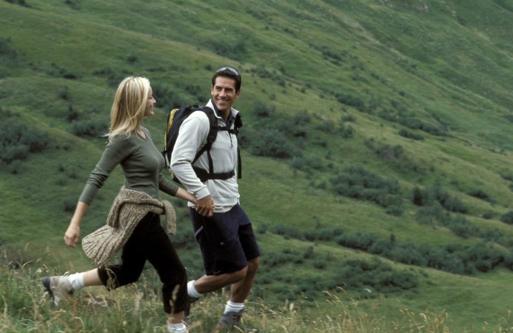 Man and woman hiking on mountainside